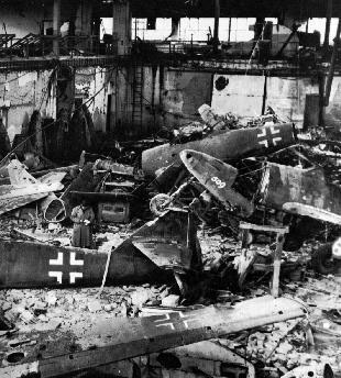 Destroyed Me 262's in a devastated factory.