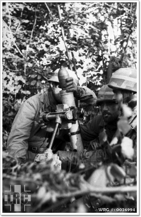 A Fallschirmjäger mortar crew firing the 8 cm Granatwerfer 42 Stummelwerfer. A Fallschirmjäger mortar crew firing the 8 cm Granatwerfer 42 Stummelwerfer.