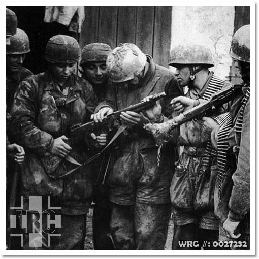 Troopers of the 2nd Fallschirmjäger Division inspect a captured Thompson SMG. Troopers of the 2nd Fallschirmjäger Division inspect a captured Thompson SMG.