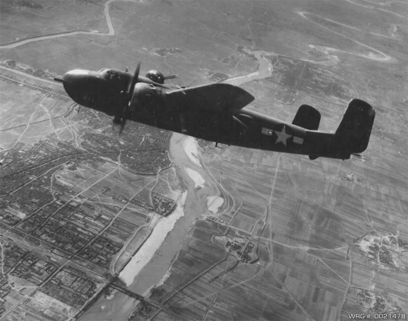 North American B-25 Mitchell of the 22nd BG, 2nd BS, 5th AF bombing a railroad bridge at Changtuikwan, China, March 11, 1945. WRG-0021478.