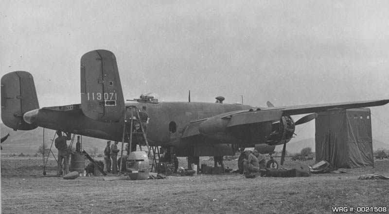 Damaged B-25C-1 Mitchell of the 310th BG being overhauled by members of the 346th Service Squardon at Berteaux, North Africa, March 5, 1943. WRG #: 0021508