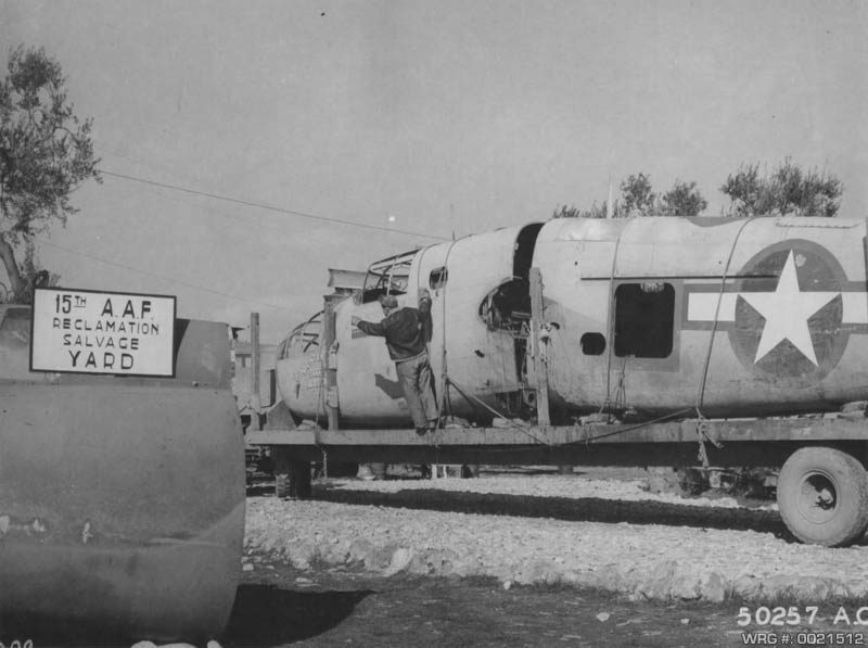 B-25 Mitchell/Sheepherder of the 15th AF, a veteran of 21 missions, is hauled to reclamation and salvage yard North Africa 1943. WRG #: 0021512