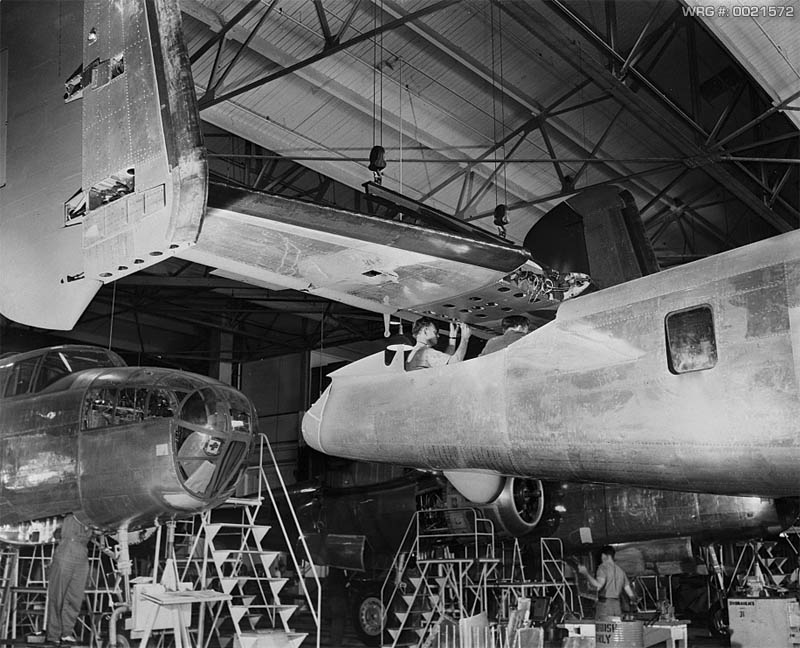 The tail assembly for a North American B-25 bomber is lowered into place from an overhead crane on the final assembly floor. WRG #: 0021572